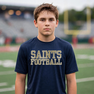 Deep navy Topeka Saints textured varsity football performance top modeled on a football field