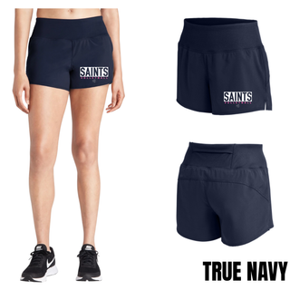 Woman wearing true navy Topeka Saints Volleyball letter block women's repeat short with white block lettering