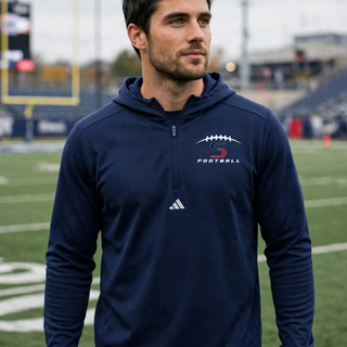Man wearing Topeka Seaman Vikings football S logo Adidas quarter zip hooded pullover in navy on football field
