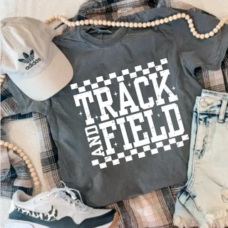 Comfort Colors pepper short sleeve top with white distressed checkered Track and Field graphic laid flat with jeans and sneakers