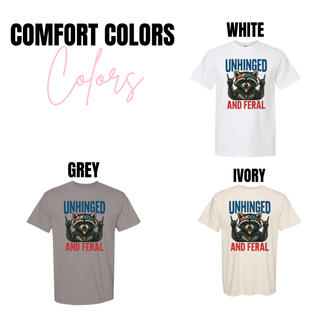 Comfort Colors Unhinged and Feral raccoon graphic tees in white, grey, and ivory
