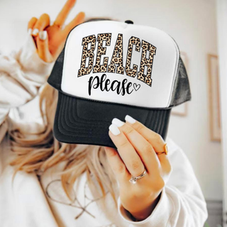 Black and white trucker hat with beach please leopard varsity graphic, lifestyle held up by woman
