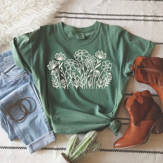 Comfort Colors light green short sleeve graphic tee laid flat with white wildflower bouquet graphic styled with jeans and brown cowboy boots