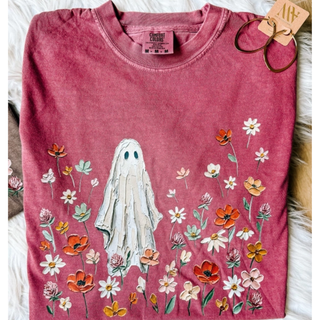 Berry Comfort Colors graphic tee with painted ghost standing in a field of wildflowers
