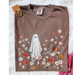 Brown Comfort Colors graphic tee with painted ghost standing in a field of wildflowers